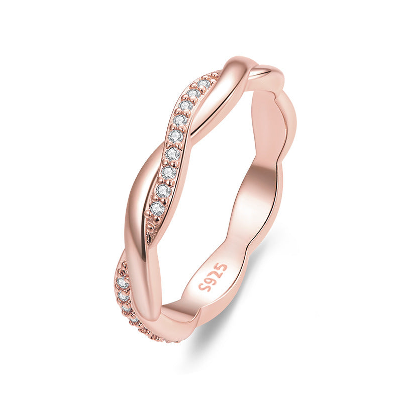 Rose gold ring with diamond accents on a white background