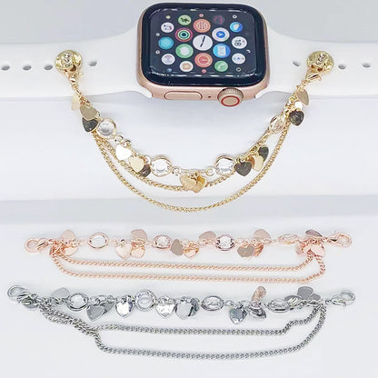 Smartwatch with multiple gold, rose gold, and silver bracelets on a white surface