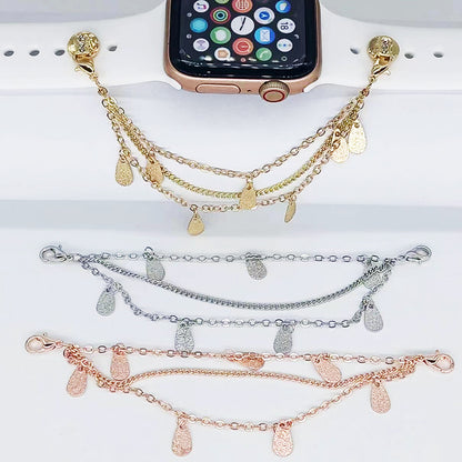 Three gold, silver, and rose gold bracelets with teardrop charms on a white surface.