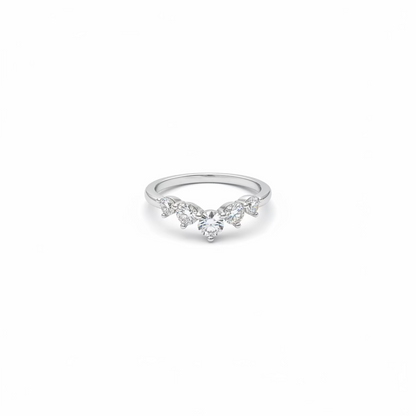 A delicate silver ring featuring a central round clear gemstone flanked by three marquise-cut gemstones, set against a plain white background.