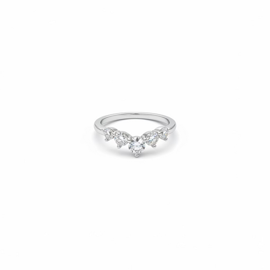 A delicate silver ring featuring a central round clear gemstone flanked by three marquise-cut gemstones, set against a plain white background.