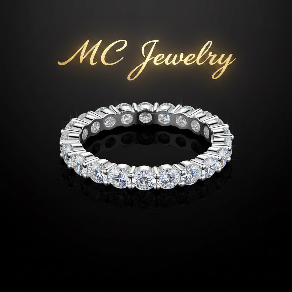 A silver-tone eternity ring set with round brilliant-cut clear stones, displayed on a reflective black background.