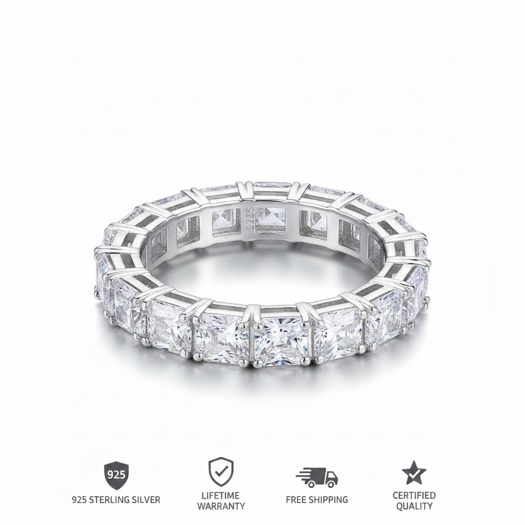 A silver-toned eternity ring featuring a continuous row of princess-cut and round diamonds in a beveled setting, shown on a clean white background.