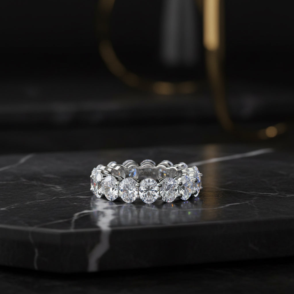 A silver-toned eternity ring featuring a row of round brilliant-cut clear stones, with an inner band stamped 'S925'.