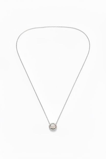 A silver chain necklace with a small circular pendant 
