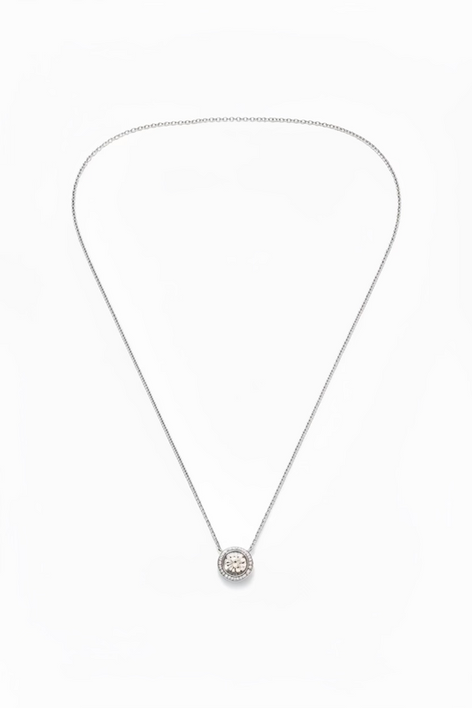 A silver chain necklace with a small circular pendant 