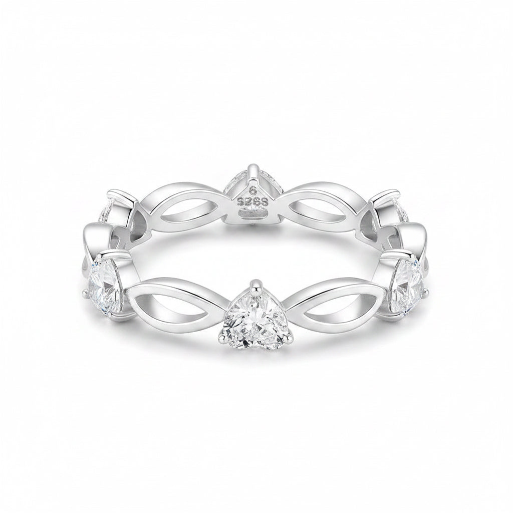 A silver eternity-style ring featuring a central triangular gemstone and smaller stones set along an openwork band, photographed on a clean white background.