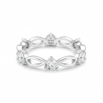 A silver eternity-style ring featuring a central triangular gemstone and smaller stones set along an openwork band, photographed on a clean white background.