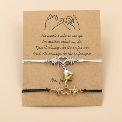 Two bracelets with heart and cupcake charms on a brown card with a quote.