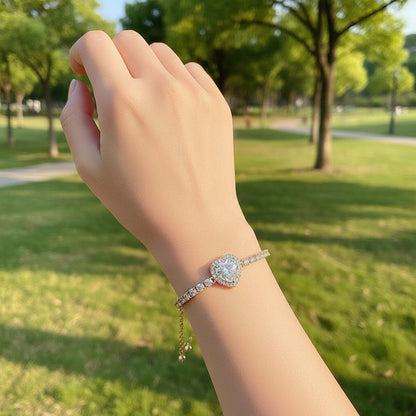 Gold bracelet with clear gemstones on a light background