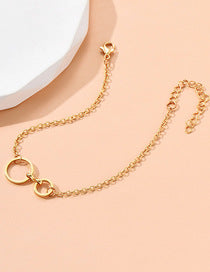 Gold chain necklace on a peach background