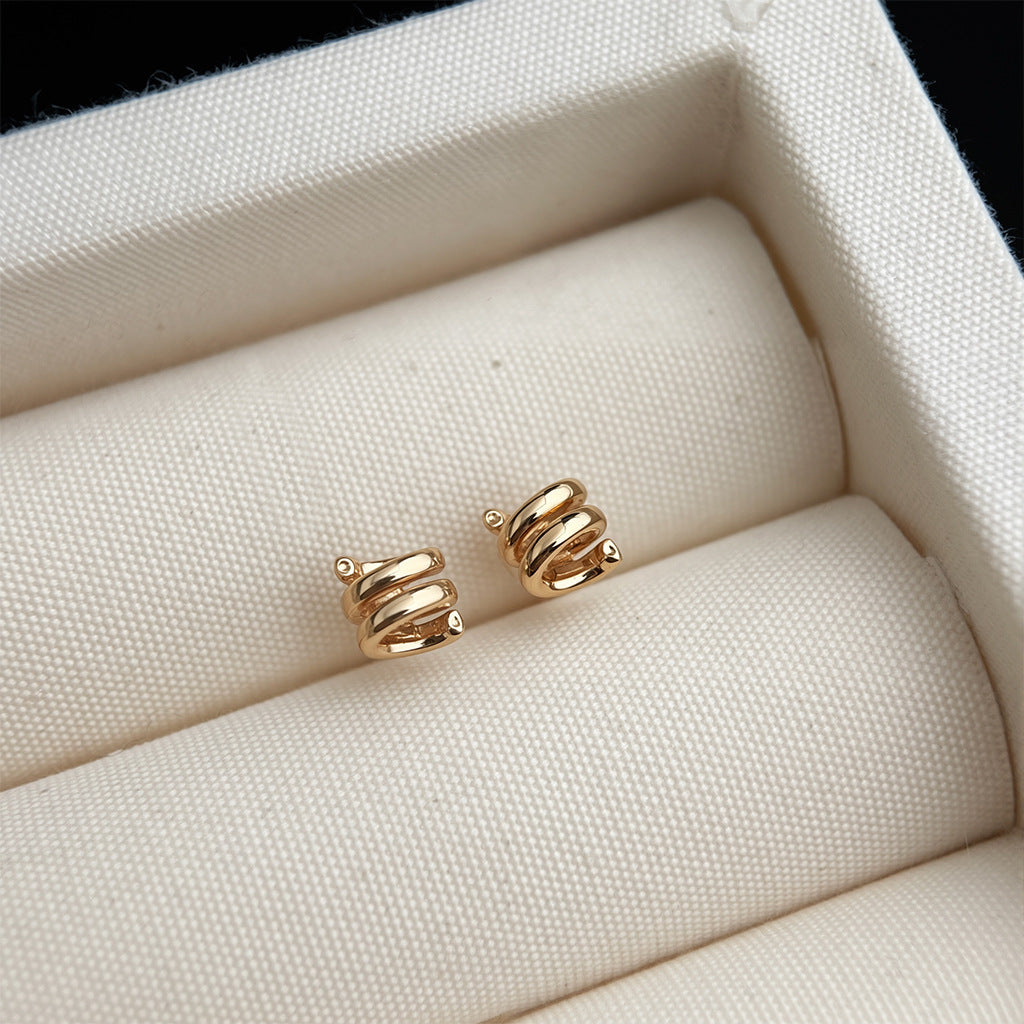 Gold spiral earrings in a jewelry box