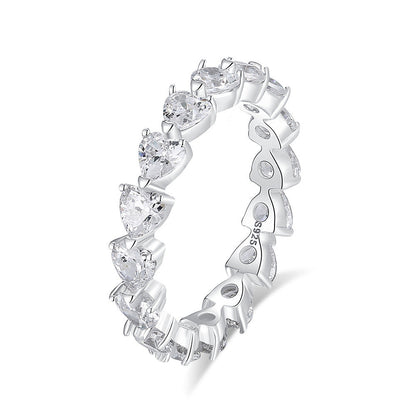 Silver ring with heart-shaped gemstones on a white background