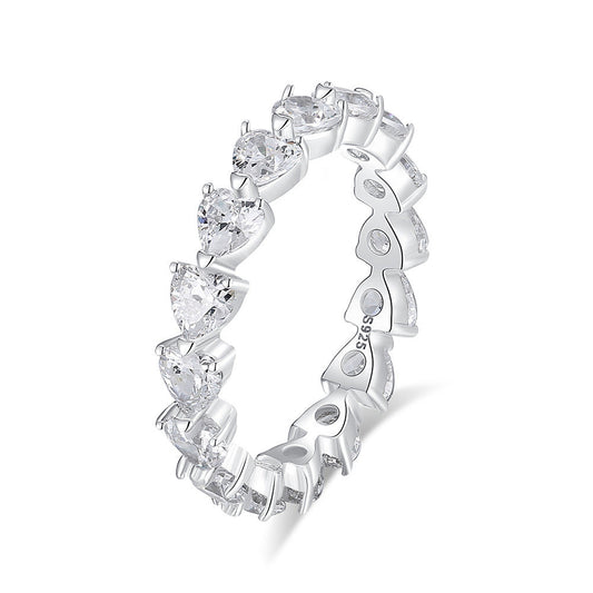 Silver ring with heart-shaped gemstones on a white background