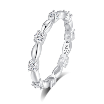 Silver ring with diamond accents on a white background
