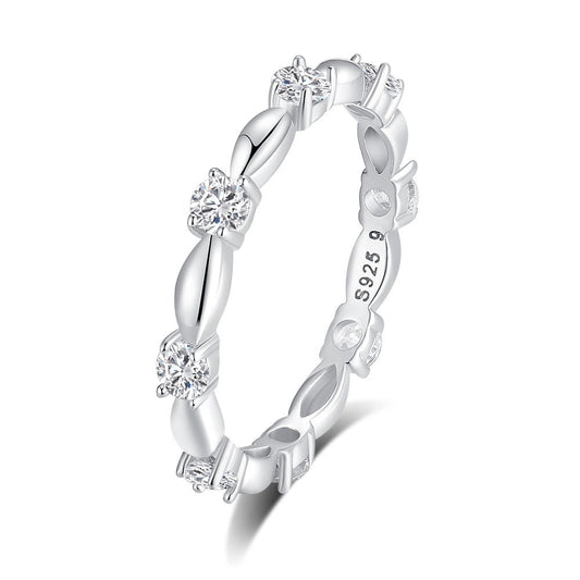 Silver ring with diamond accents on a white background