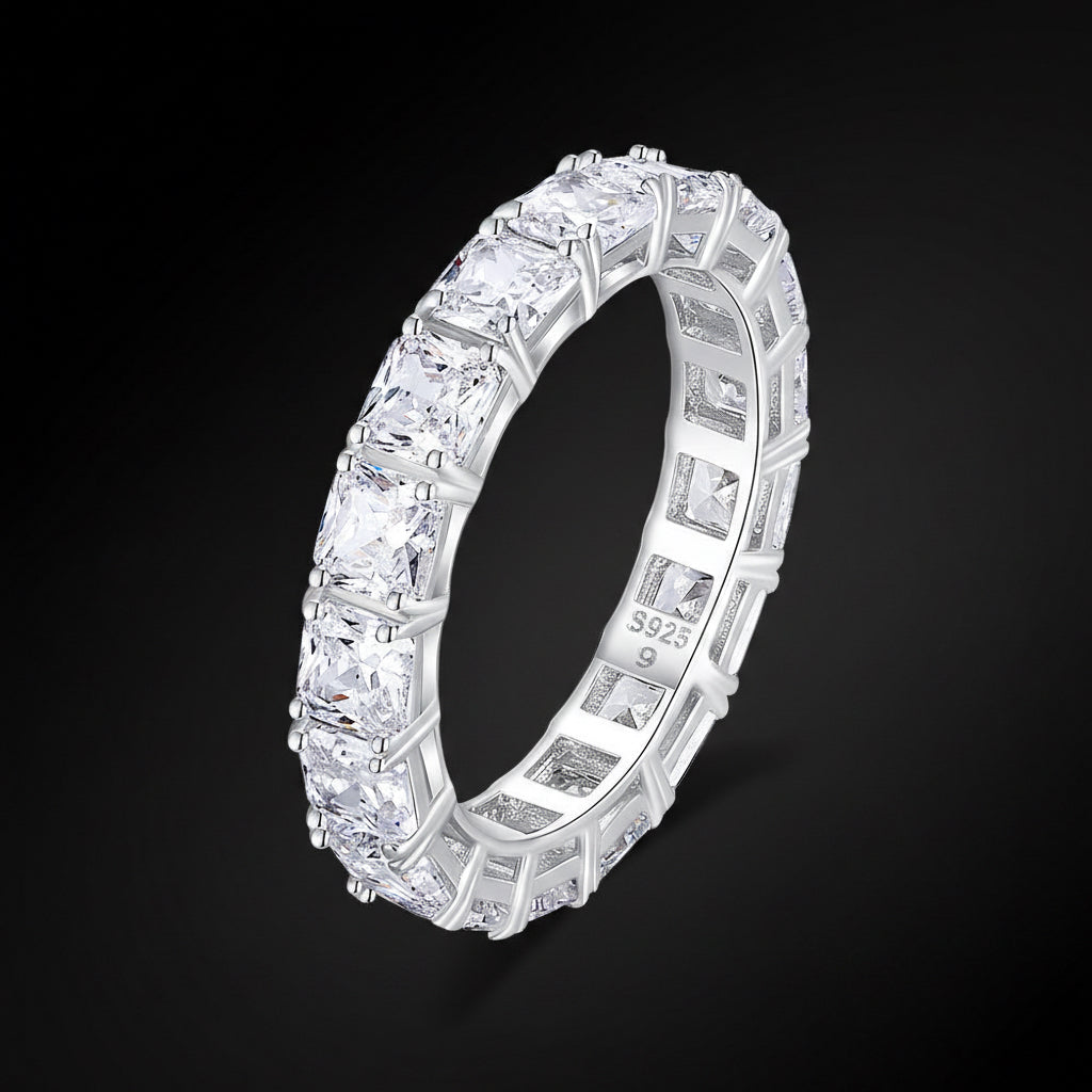 Silver ring with multiple diamonds on a white background