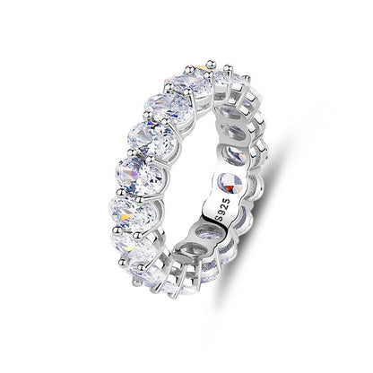 Silver ring with clear gemstones on a white background