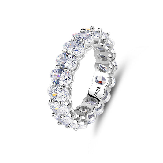 Silver ring with clear gemstones on a white background