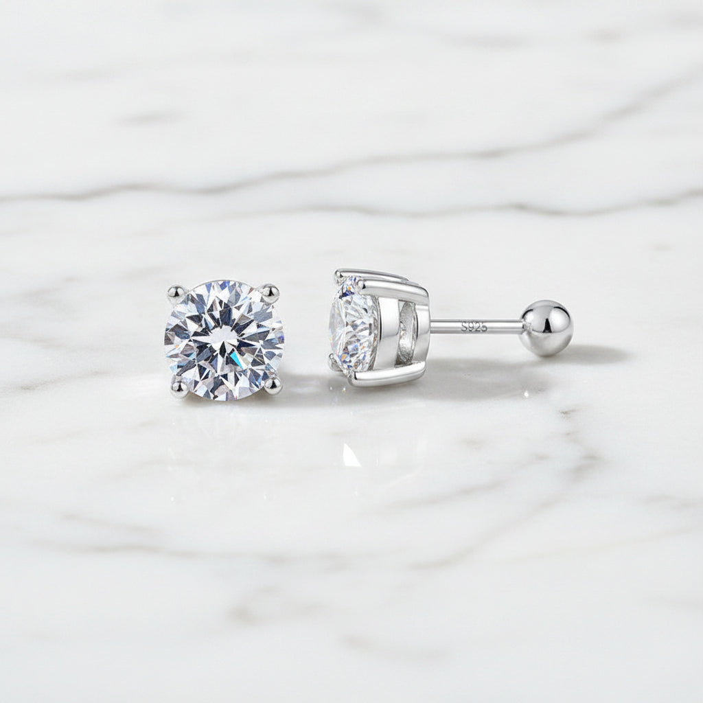 Pair of silver stud earrings with clear gemstones on a white background