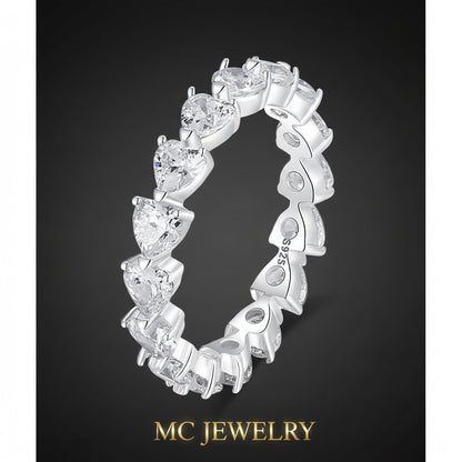 Silver ring with heart-shaped gemstones on a white background