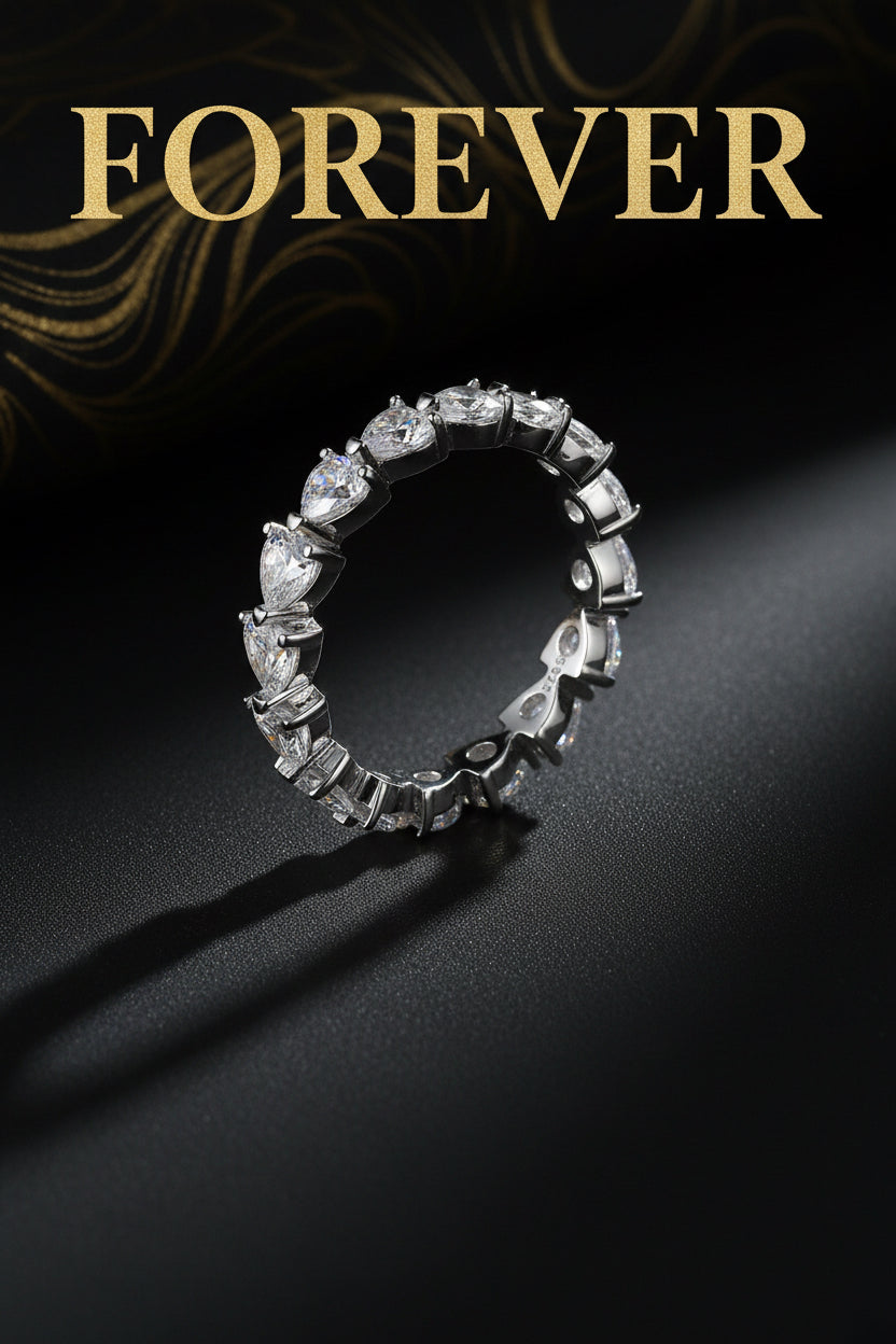 Silver ring with heart-shaped gemstones on a white background