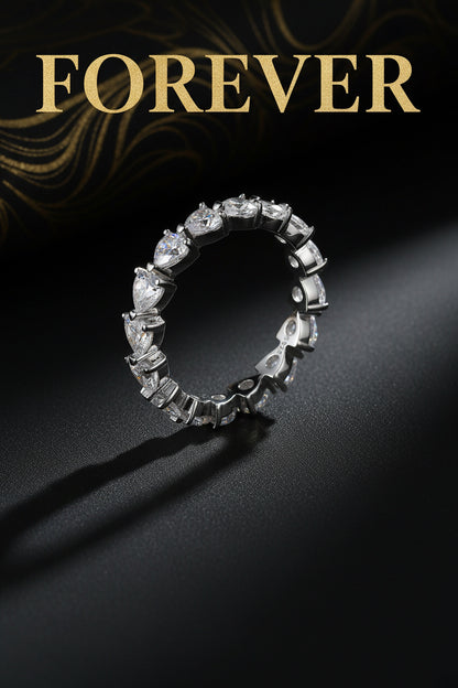 Silver ring with heart-shaped gemstones on a white background