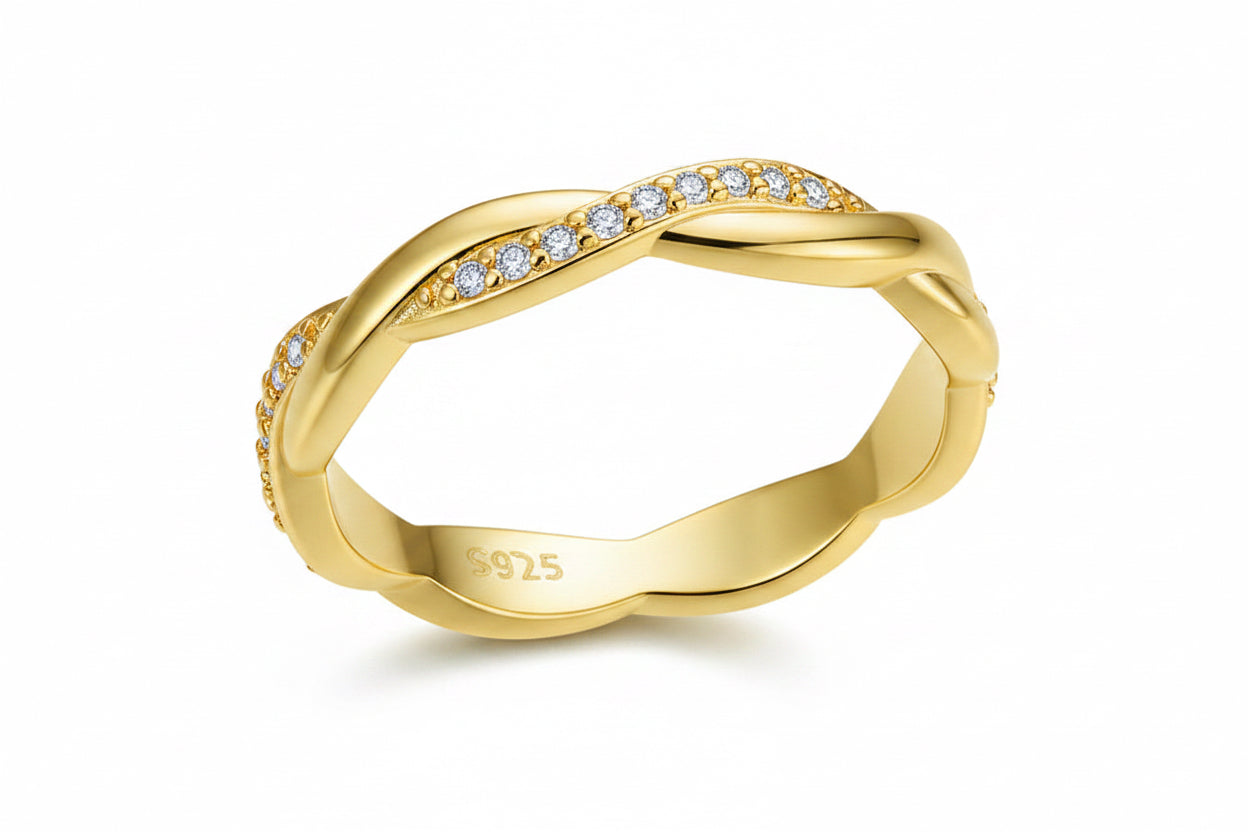 Gold ring with diamond accents on a white background
