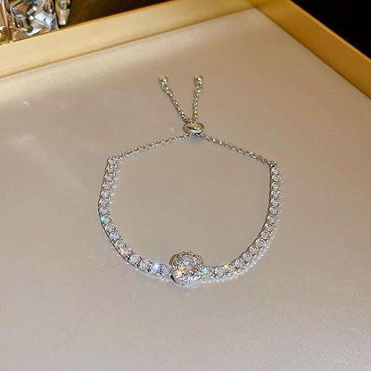 Silver bracelet with clear stones on a light background