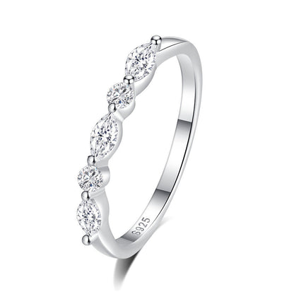 Silver ring with clear gemstones on a white background