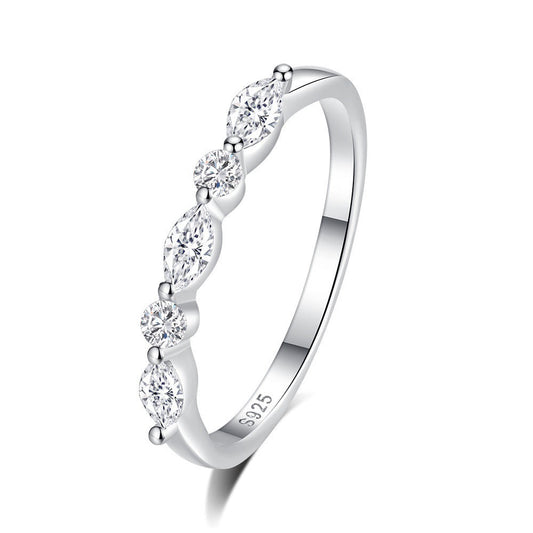 Silver ring with clear gemstones on a white background