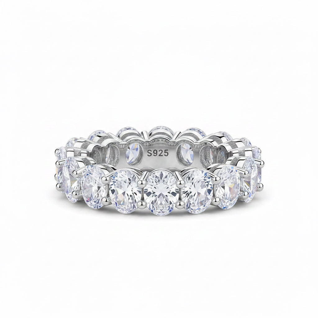 Silver ring with clear gemstones on a white background