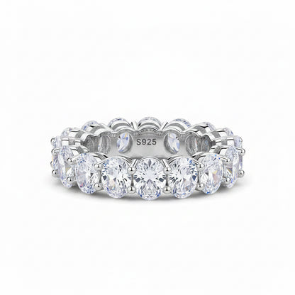 Silver ring with clear gemstones on a white background