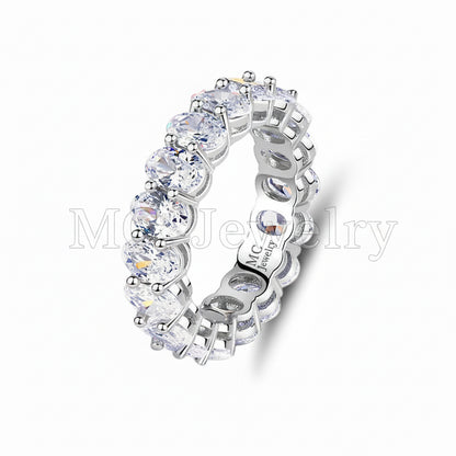 Silver ring with clear gemstones on a white background