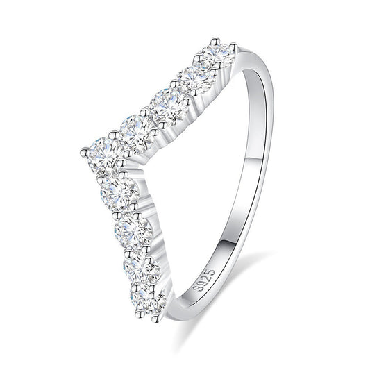 Silver ring with diamond accents on a white background