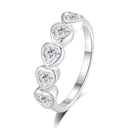 Silver ring with heart-shaped gemstones on a white background