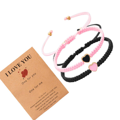 Two braided bracelets with heart charms and a card reading 'I LOVE YOU' on a white background.
