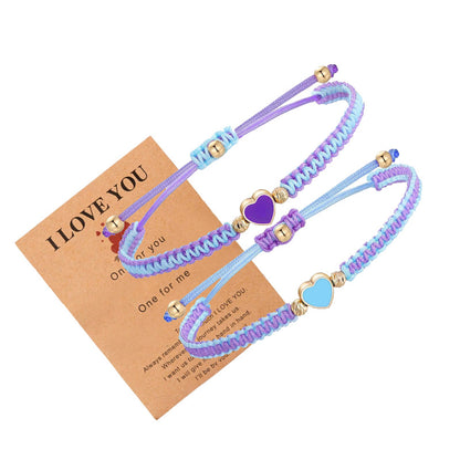 Two braided bracelets with heart-shaped charms on a 'I LOVE YOU' card.