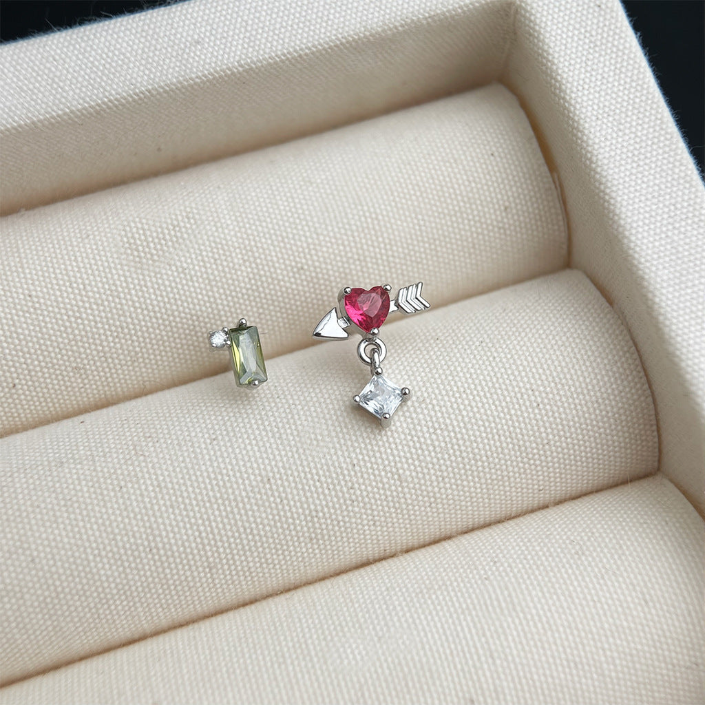 Two earrings on a soft beige surface