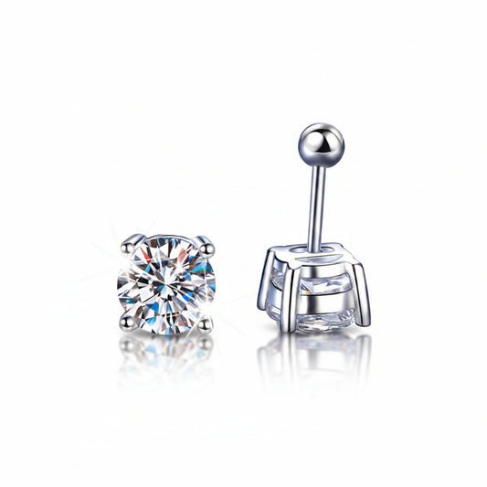 Two_silver_earrings_with_clear_gemstones_on_a_blue_textured_background