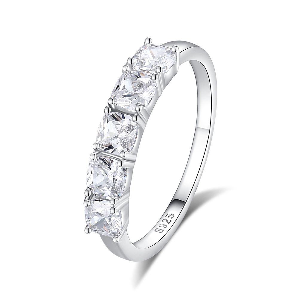 Silver ring with clear gemstones on a white background
