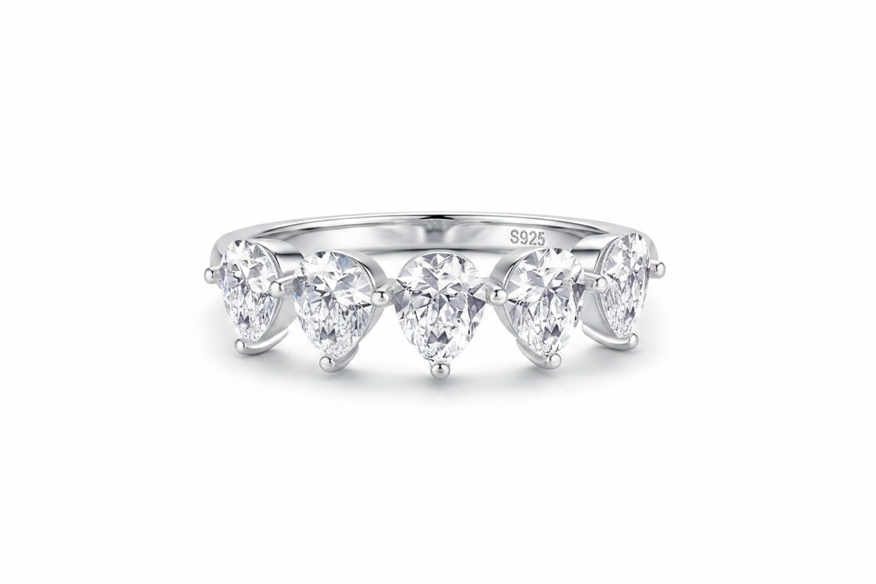 Silver ring with three heart-shaped diamonds on a white background