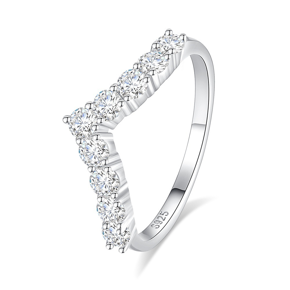 Silver ring with diamond accents on a white background
