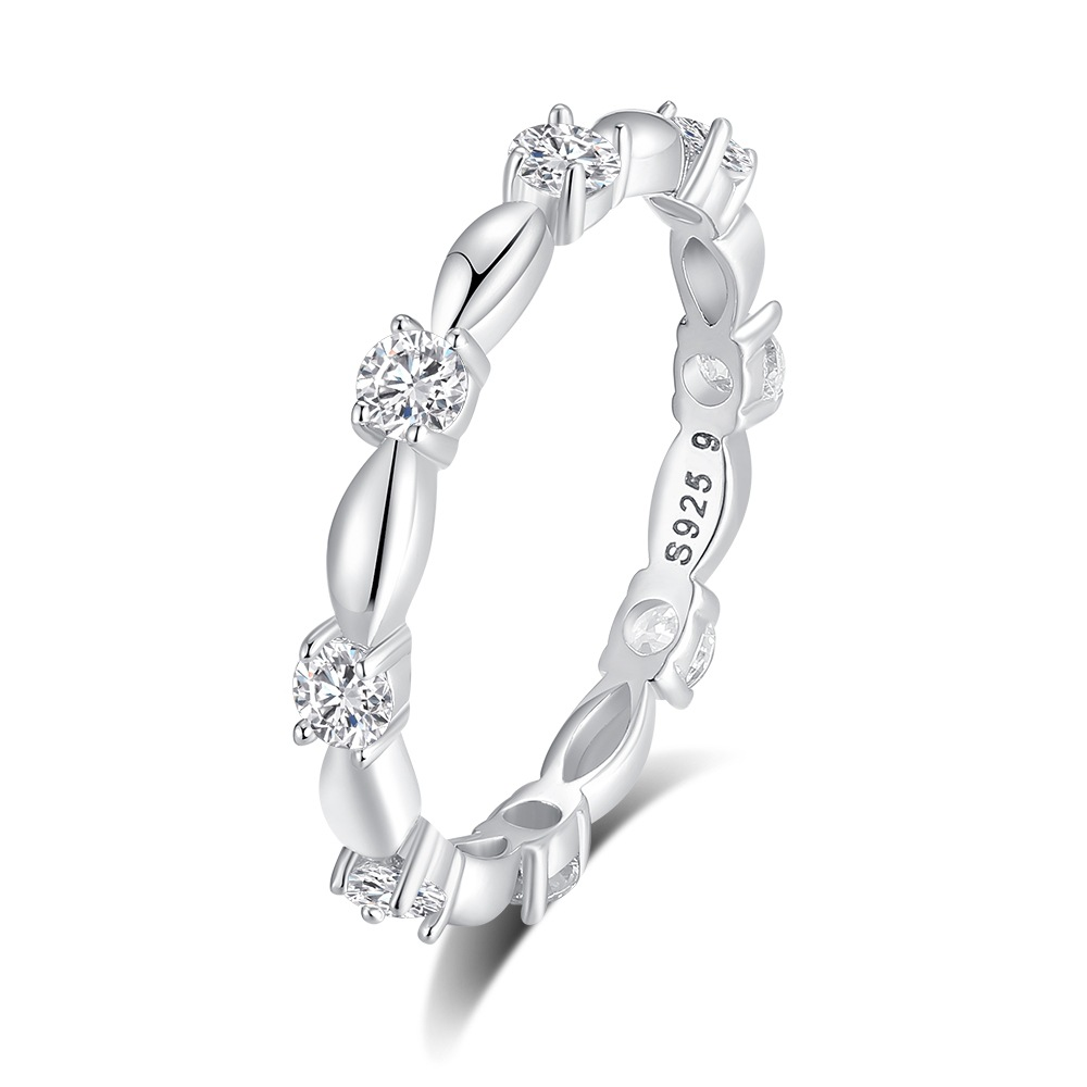 Silver ring with diamond accents on a white background